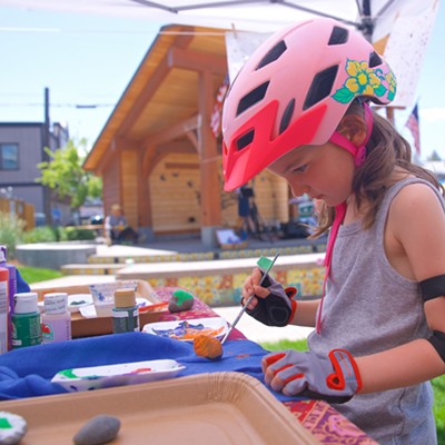 A young visitor paints rocks at Sisters Farmers Market