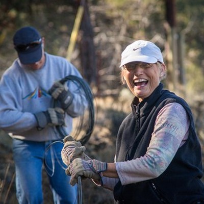 Volunteers help remove fencing to protect wildlife on Land Trust Preserve.