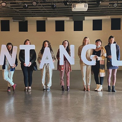 People hold "Entangle" written in individual letters