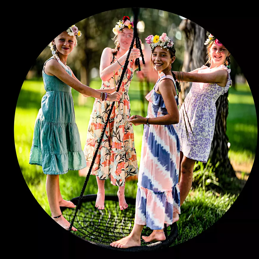 4 young girls on a swing