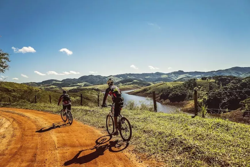 cyclists-trail-bike-clouds-163407.webp