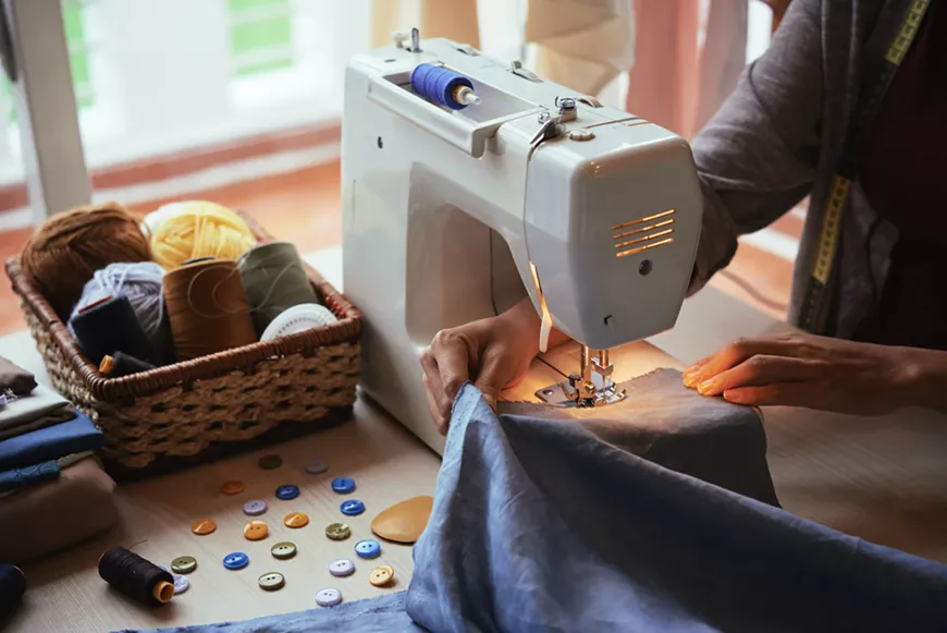 using-a-sewing-machine-scaled_1296x.jpg.webp