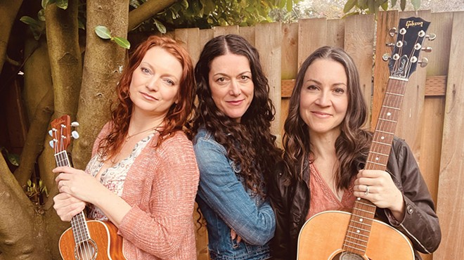 The three members of The Cider Janes pose for a photo with guitars