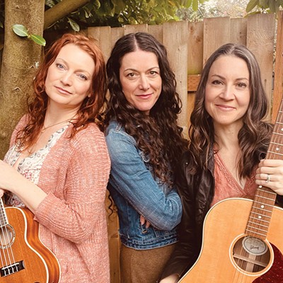 The three members of The Cider Janes pose for a photo with guitars