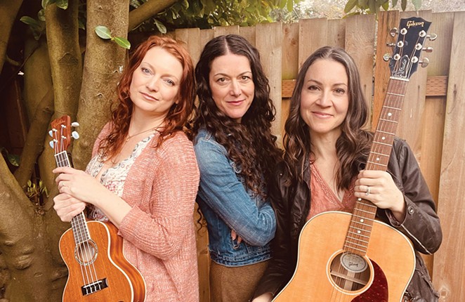 The three members of The Cider Janes pose for a photo with guitars