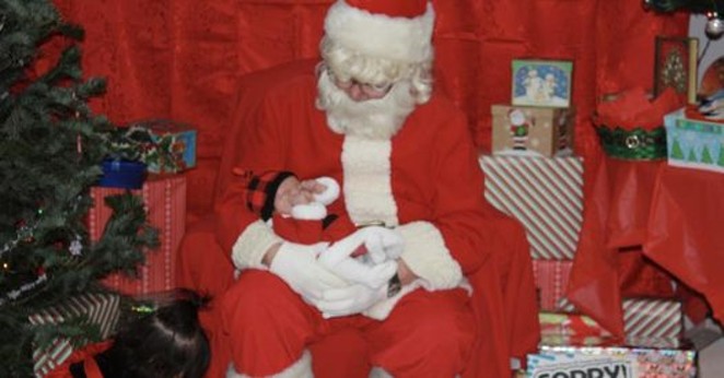 Santa greets a small admirer at the 2021 event