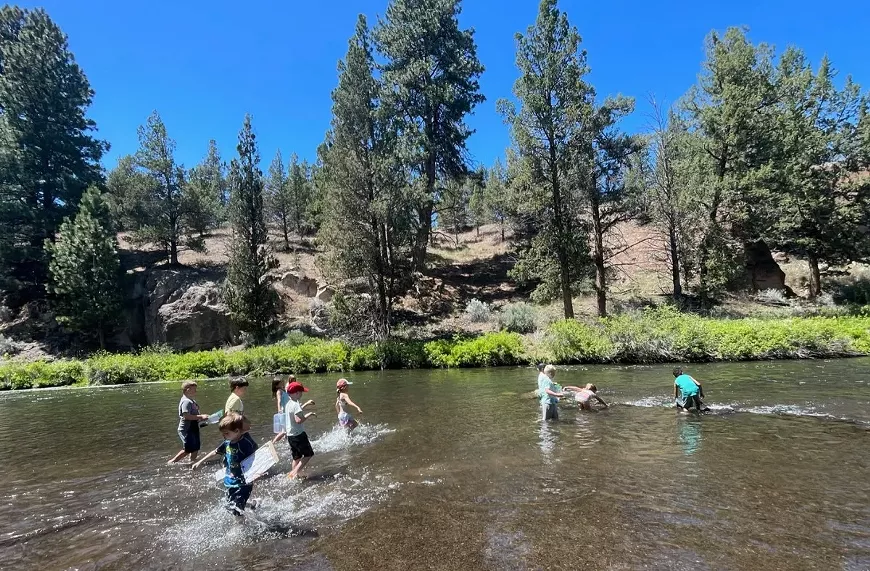 Campers explore Tumalo Creek during Wild Wonders Summer Camp