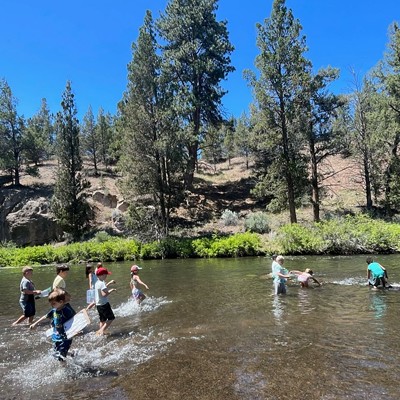 Campers explore Tumalo Creek during Wild Wonders Summer Camp